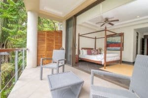 Balinese-inspired bedroom with ocean view from balcony in Dominical, Costa Rica.
