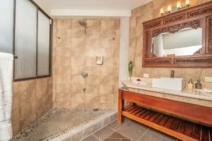 Elegant bathroom with walk-in shower and Balinese-inspired decor.
