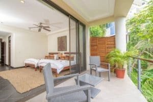 Balinese-style home with ocean view balcony and outdoor seating area.