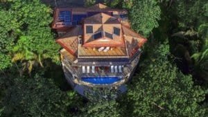 Aerial view of a Balinese-inspired luxury home with ocean view in Dominical.