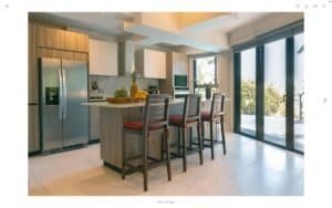 Contemporary kitchen with ocean view, island, and dining area in Dominical.