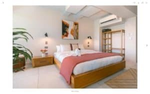 Modern bedroom with ocean view, minimalist decor, and Balinese-inspired style.
