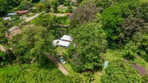 Fully renovated Costa Rican-style home surrounded by lush greenery and streams.