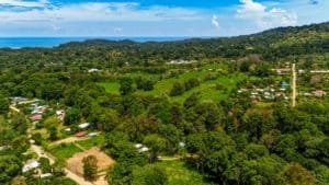 A lush green landscape with streams and a fully renovated home in Dominical, Costa Rica.