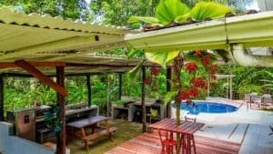 Outdoor patio with seating, pool, and lush tropical plants in Dominical.