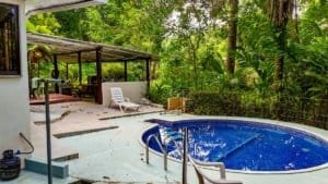 Fully renovated Costa Rican-style home with pool, streams, and lush greenery.