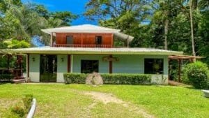 Fully renovated Costa Rican-style home with streams and lush greenery.