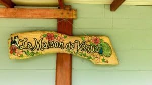 Colorful wooden sign reading La Maison de Venus in Dominical, Costa Rica.