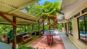 Beautiful Costa Rican home with pool, lush garden, and outdoor dining area.