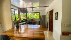 Bright kitchen with large windows, wooden countertops, and modern appliances.