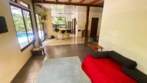 Interior of a Costa Rican home with pool view, modern decor, and open layout.