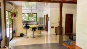 Bright, open kitchen with bar stools and large window in Costa Rica.