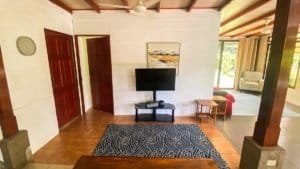 Interior of a Costa Rican home with wooden beams and a view to the outdoor area.