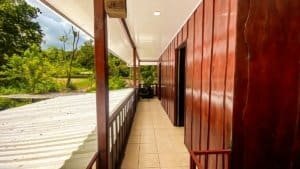 Porch of a renovated Costa Rican-style home with streams nearby.