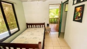 Interior of a cozy Costa Rican-style home with balcony and natural light.