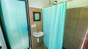 Bathroom of a Costa Rican home with shower and sink in Dominical area.