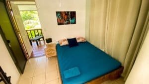 Cozy bedroom with balcony and tropical views in Dominical.