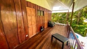 Fully renovated Costa Rican-style home balcony with lush greenery and streams.