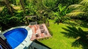 Fully renovated Costa Rican-style home with pool, streams, and lush greenery.