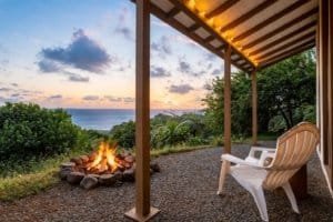 Relaxing oceanview sunset scene with fire pit and porch in Dominical.