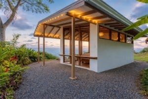 Private rainforest estate with ocean view and outdoor seating area.