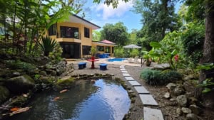 Luxury home in Dominical with pool, waterfall, and lush tropical garden.