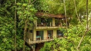 Two-story tropical villa surrounded by lush green jungle in Dominical.