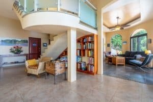 Spacious living room with high ceilings, large windows, and cozy seating area.