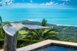 Scenic ocean view with lush greenery and blue sea in Dominical, Costa Rica.
