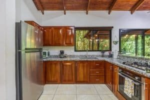 Modern kitchen with wooden cabinets and stainless steel appliances in Costa Rica.
