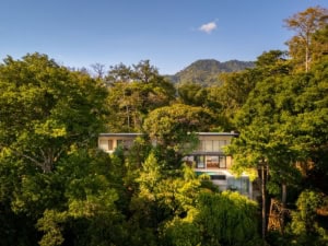 Modern tropical home surrounded by lush greenery and mountains in Dominical.