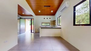 Bright, modern kitchen with large windows and wooden ceiling in Dominical.