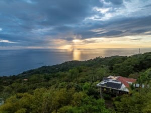 Elevated ocean view home surrounded by lush greenery in Dominical, Costa Rica.