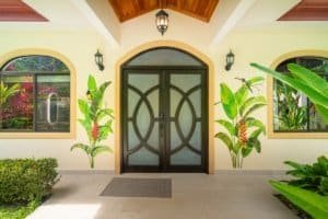 Elegant entrance of a jungle home with tropical plants in Dominical, Costa Rica.