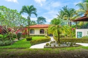 Lush tropical garden with modern house and palm trees in Dominical.