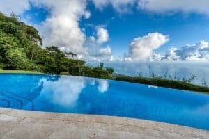 Infinity pool overlooking lush jungle and ocean in Dominical, Costa Rica.