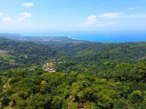 Stunning ocean view from Dominical with lush greenery and whale's tail formation.