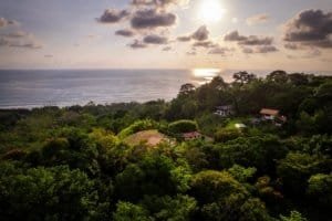Lush green tropical forest with ocean view and sunset in Dominical, Costa Rica.