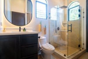 Bathroom with walk-in shower, modern fixtures, and tropical decor in Dominical.