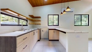 Bright modern kitchen with wooden accents and large windows in Dominical.