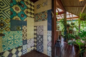 Colorful tiled wall and lush greenery in Dominical, Costa Rica.