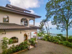 Beautiful ocean view villa with lush garden and tropical trees in Dominical.
