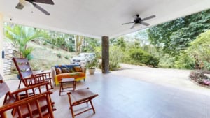 Outdoor covered patio with chairs and scenic view in Dominical.