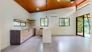 Spacious modern kitchen with wooden ceiling and large windows in Dominical.