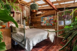Interior of a rainforest home in Dominical with wooden decor and lush plants.