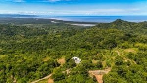 Panoramic ocean and mountain view from a lush Costa Rican estate.
