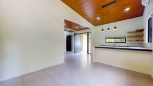 Spacious modern interior of a Dominical property with wooden ceiling and open layout.