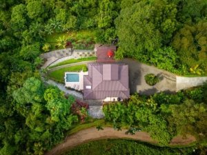 Aerial view of a Mediterranean-style villa with ocean view in Dominical, Costa Rica.