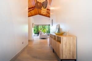 Bright interior of a modern jungle home with a view of greenery outside.