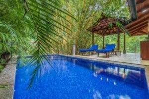 Luxury tropical villa pool surrounded by lush jungle in Dominical, Costa Rica.
